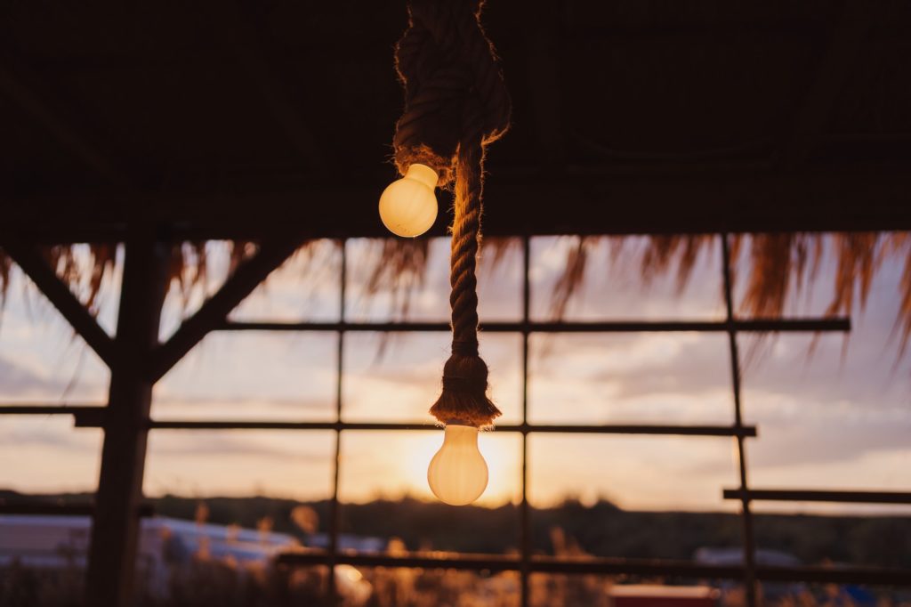 Beach bar light bulbs at sunset